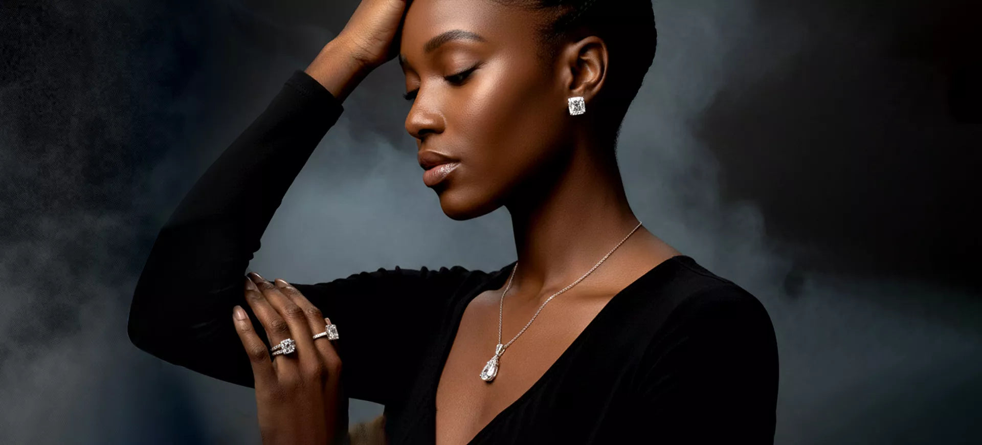 Happy couple embracing by the snowy beach, with the woman proudly showcasing her sparkling diamond engagement ring and wedding band, symbolizing love and commitment.